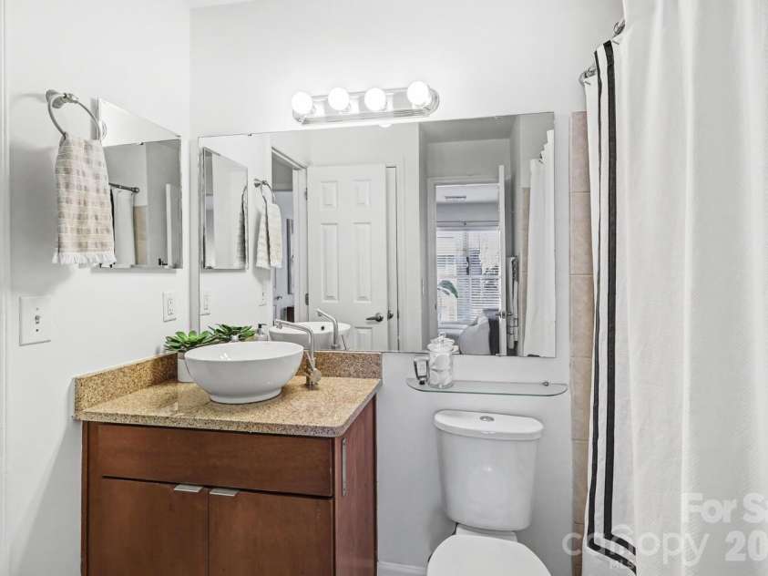 525 Graham Street, Charlotte, NC 28202.  MLS# CAR4341824, YatesRealty ID 4546. Clean, modern bath with granite vanity and vessel sink for a polished look
