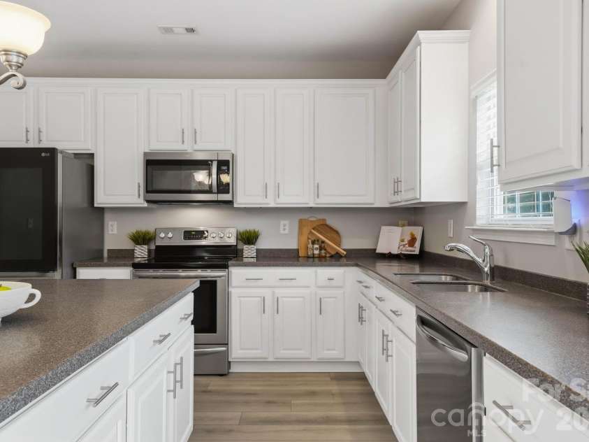 1001 Yellow Daisy Drive, Matthews, NC 28104.  MLS# CAR4415570, YatesRealty ID 45480. Abundant cabinetry and counter space make this kitchen as functional as it is inviting.