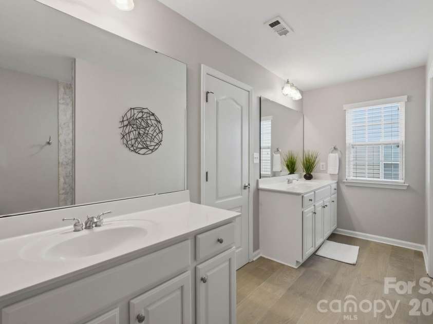 1001 Yellow Daisy Drive, Matthews, NC 28104.  MLS# CAR4415570, YatesRealty ID 45480. Beautifully updated primary bath creates a fresh, modern retreat.