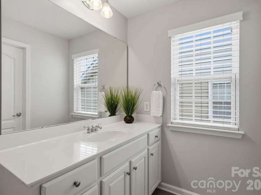 1001 Yellow Daisy Drive, Matthews, NC 28104.  MLS# CAR4415570, YatesRealty ID 45480. Modern finishes and beautiful tilework elevate the primary suite.