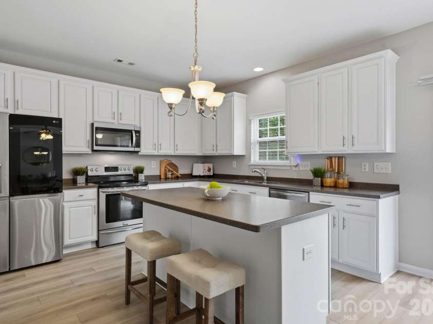 1001 Yellow Daisy Drive, Matthews, NC 28104.  MLS# CAR4415570, YatesRealty ID 45480. Spacious kitchen designed to keep cooking, dining and entertaining connected.