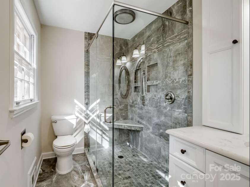 2111 Sagamore Road, Charlotte, NC 28209.  MLS# CAR4323130, YatesRealty ID 455. Frameless glass/tile shower