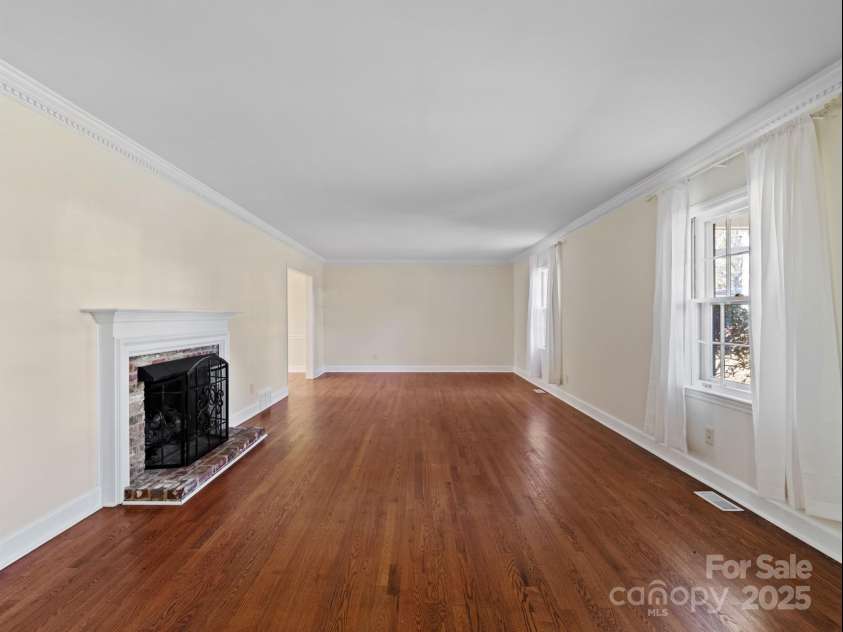2111 Sagamore Road, Charlotte, NC 28209.  MLS# CAR4323130, YatesRealty ID 455. Living room with newly refinished hardwood floors and gas fireplace!