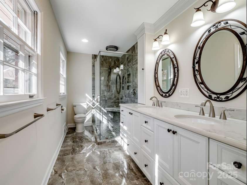 2111 Sagamore Road, Charlotte, NC 28209.  MLS# CAR4323130, YatesRealty ID 455. Primary bath with custom tile and dual sink vanity