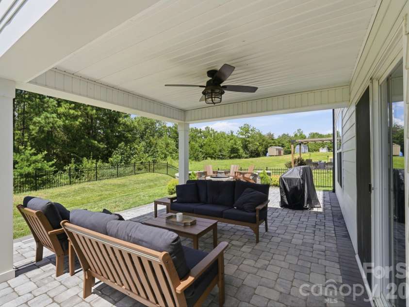 4492 Falls Lake Drive, Concord, NC 28025.  MLS# CAR4413181, YatesRealty ID 45507. Covered paver patio with ceiling fan.