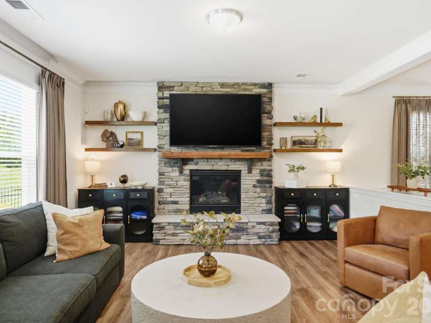 4492 Falls Lake Drive, Concord, NC 28025.  MLS# CAR4413181, YatesRealty ID 45507. Great Room with rustic stone fireplace and shelving.