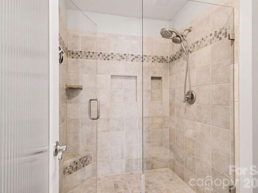 18613 Vineyard Point Lane, Cornelius, NC 28031.  MLS# CAR4409285, YatesRealty ID 45514. Walk-in shower with bench and stoage