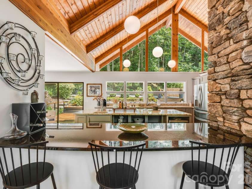 2752 Gerton Highway, Gerton, NC 28735.  MLS# CAR4409357, YatesRealty ID 45515. Bar seating and dramatic stonework create a natural connection between the kitchen and great room