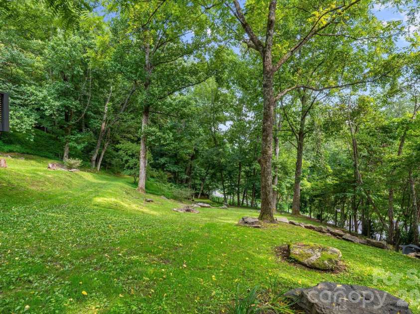 2752 Gerton Highway, Gerton, NC 28735.  MLS# CAR4409357, YatesRealty ID 45515. Open lawn area surrounded by mature trees