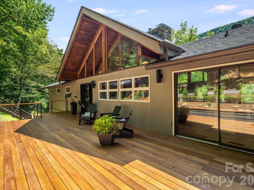2752 Gerton Highway, Gerton, NC 28735.  MLS# CAR4409357, YatesRealty ID 45515. Spacious front deck offering a welcoming outdoor space surrounded by the wooded mountain setting