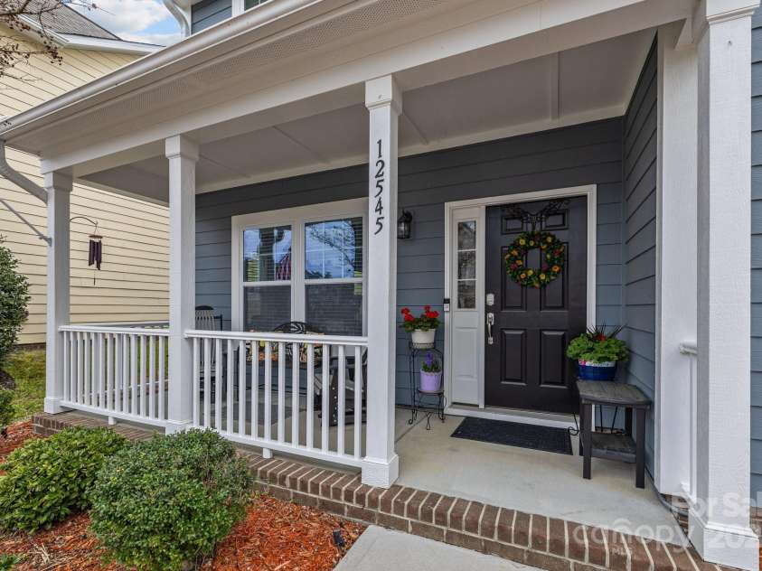 12545 Druids Glen Drive, Pineville, NC 28134.  MLS# CAR4234518, YatesRealty ID 4552. Front porch has vinyl railings