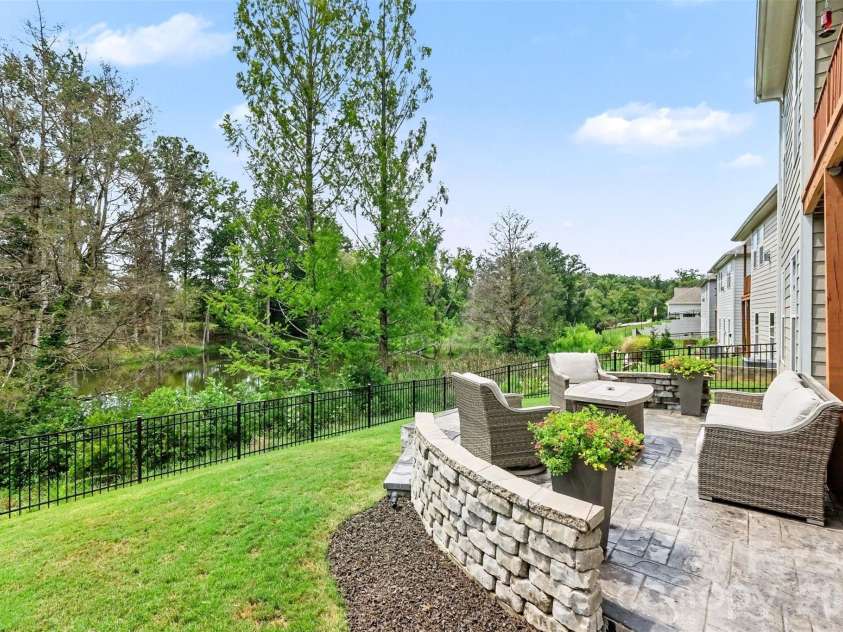 676 Latrobe Drive, Iron Station, NC 28080.  MLS# CAR4401657, YatesRealty ID 45521. Beautiful wooded pond view, creating a peaceful and picturesque backdrop