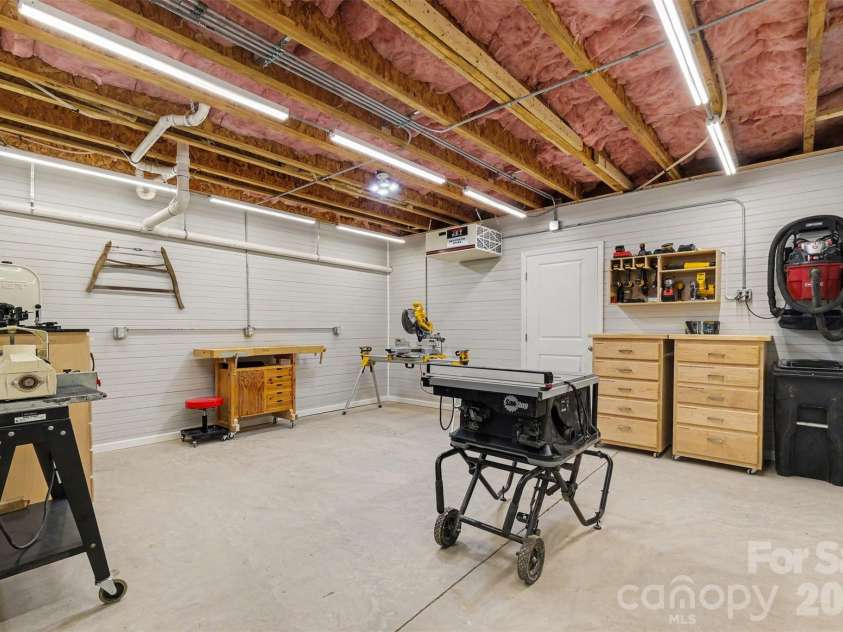 676 Latrobe Drive, Iron Station, NC 28080.  MLS# CAR4401657, YatesRealty ID 45521. Dedicated basement workshop with ample space for projects or hobbies