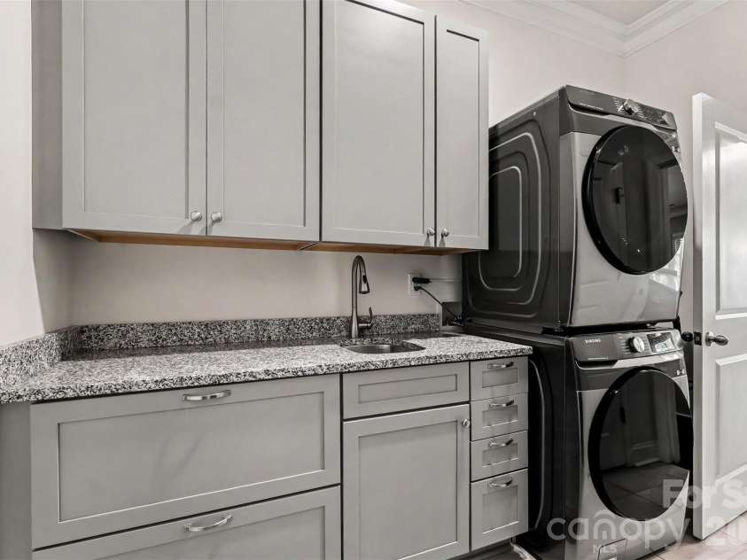 676 Latrobe Drive, Iron Station, NC 28080.  MLS# CAR4401657, YatesRealty ID 45521. Functional laundry room featuring ample cabinetry ,sink and convenient drop zone. There is room to have washer and dryer side by side.