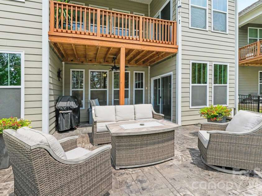 676 Latrobe Drive, Iron Station, NC 28080.  MLS# CAR4401657, YatesRealty ID 45521. Spacious lower-level patio overlooking the backyard, perfect for relaxing , entertaining, and enjoying the outdoors