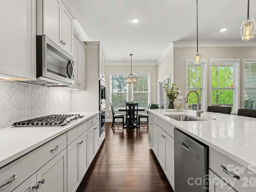 676 Latrobe Drive, Iron Station, NC 28080.  MLS# CAR4401657, YatesRealty ID 45521. Stylish kitchen with gas range, double oven, quartz countertops and ample workspace