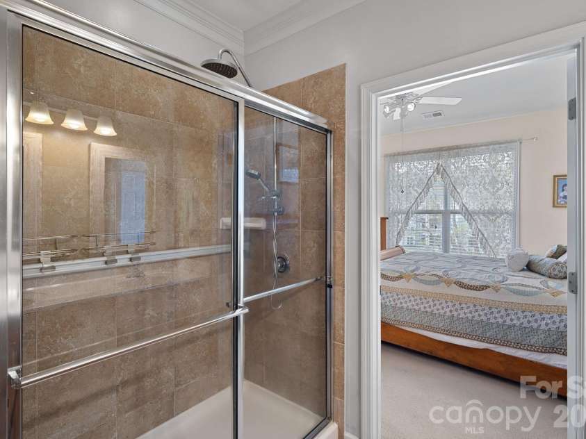 18742 Nautical Drive, Cornelius, NC 28031.  MLS# CAR4343939, YatesRealty ID 4553. Tile shower with glass sliding doors