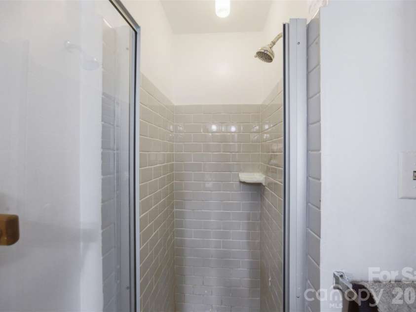 5218 Dolphin Lane, Charlotte, NC 28215.  MLS# CAR4415412, YatesRealty ID 45538. Primary tile shower