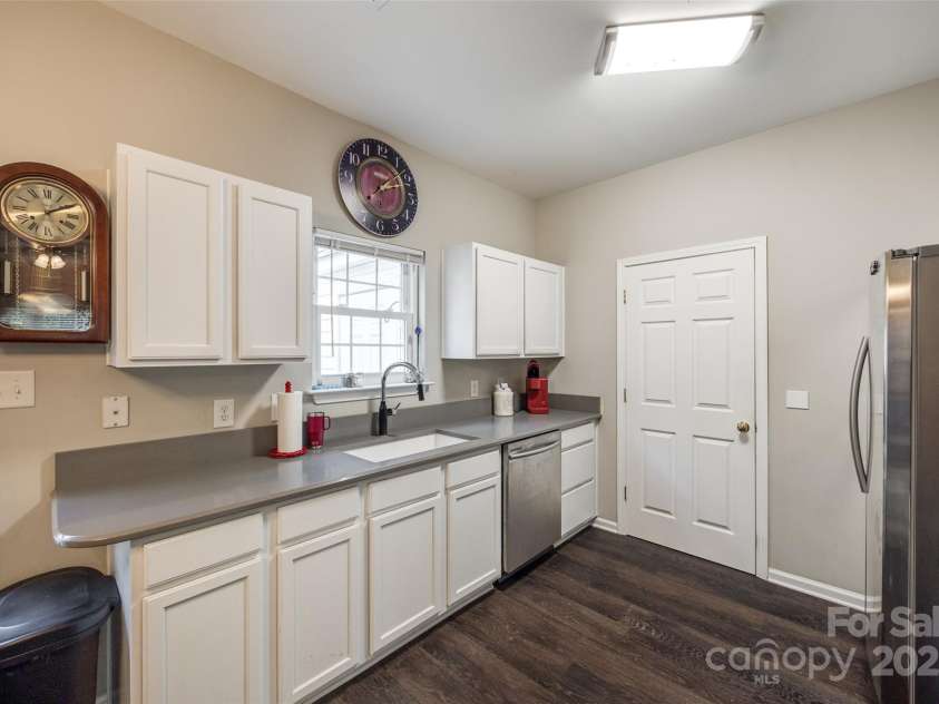 140 Reid Lane, Pineville, NC 28134.  MLS# CAR4227659, YatesRealty ID 4555. Kitchen with new Corian countertops, large sink and stainless appliances