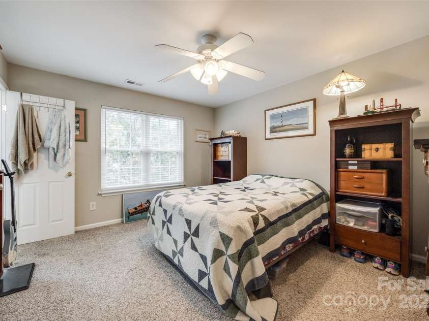 140 Reid Lane, Pineville, NC 28134.  MLS# CAR4227659, YatesRealty ID 4555. Spacious primary bedroom with walk-in closet and attached full bathroom