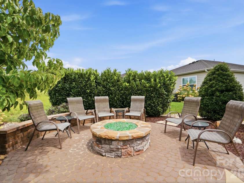 6127 Raven Rock Drive, Denver, NC 28037.  MLS# CAR4414430, YatesRealty ID 45559. The firepit and lighted seating wall create an inviting destination for cool evenings and good conversation.
