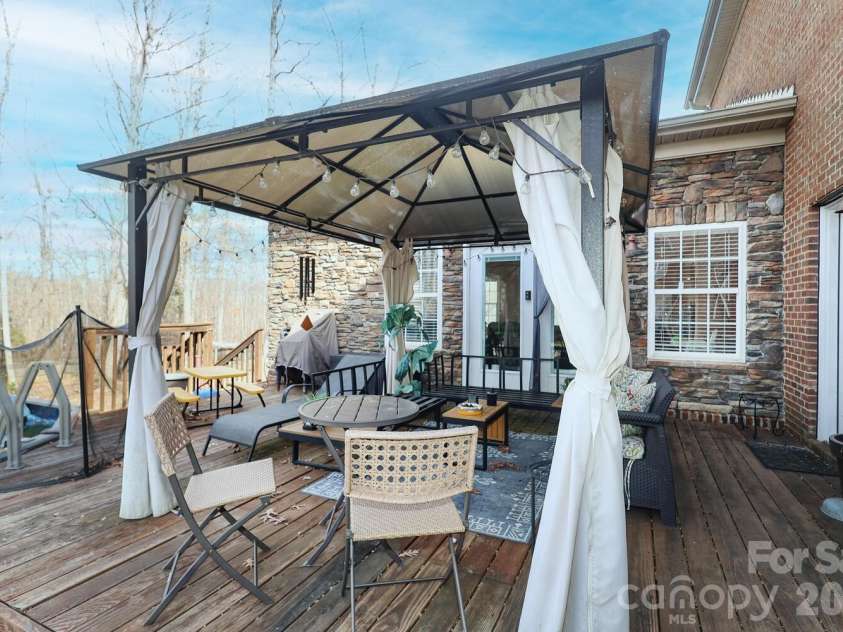 5001 Ardenwoods Drive, Charlotte, NC 28215.  MLS# CAR4315920, YatesRealty ID 4558. This covered deck overlooks backyard and pool!