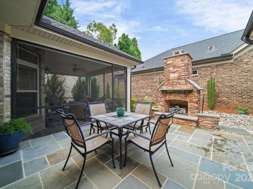 5256 Courtyard Lane, Belmont, NC 28012.  MLS# CAR4299282, YatesRealty ID 4561. Courtyard with slate tile and stack stone fireplace