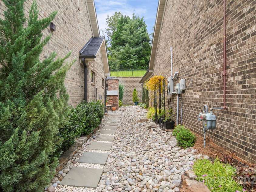 5256 Courtyard Lane, Belmont, NC 28012.  MLS# CAR4299282, YatesRealty ID 4561. Up lighting in the courtyard hardscape