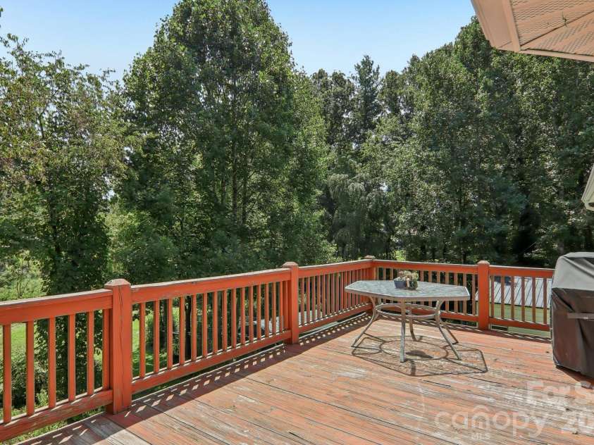 1414 Kanuga Road, Hendersonville, NC 28739.  MLS# CAR4415516, YatesRealty ID 45627. Deck overlooking back yard