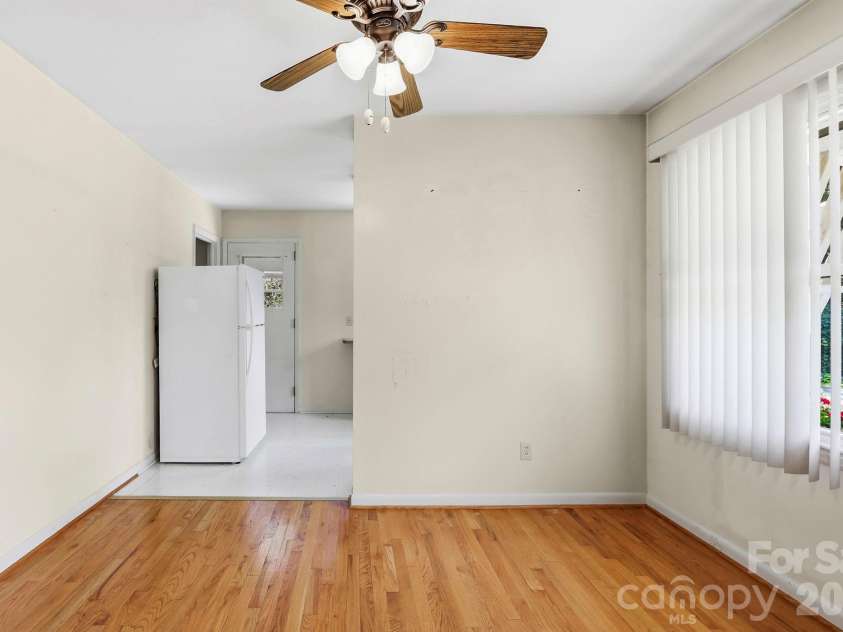 27 McGee Circle, Fairview, NC 28730.  MLS# CAR4415904, YatesRealty ID 45673. Bright dining area features hardwood floors, ceiling fan, and easy flow into the kitchen.
