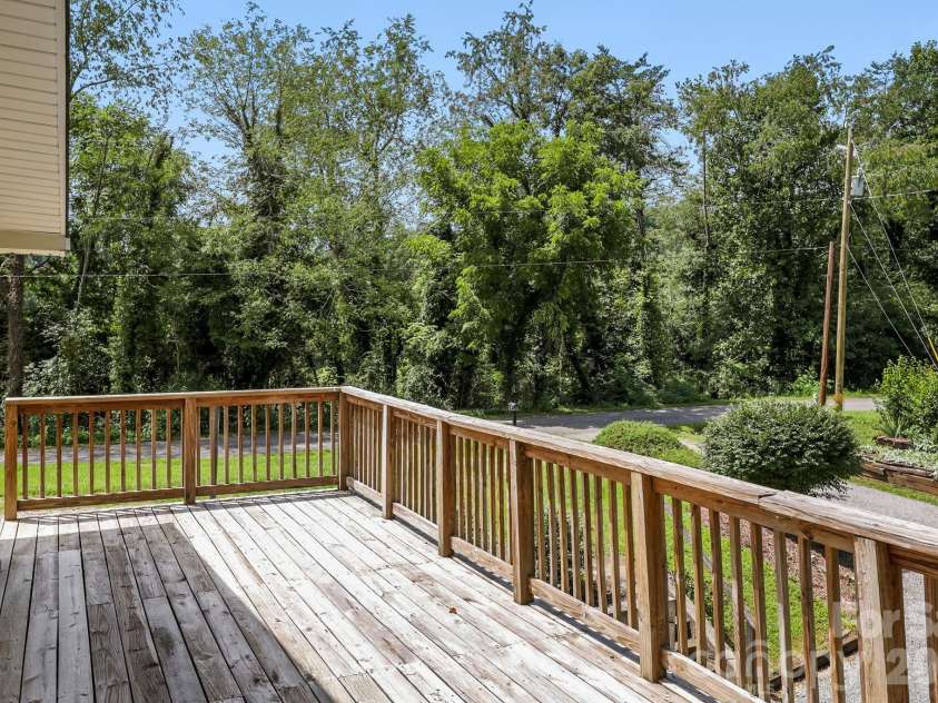 27 McGee Circle, Fairview, NC 28730.  MLS# CAR4415904, YatesRealty ID 45673. Generous elevated deck provides ample space for outdoor seating, entertaining, and enjoying the peaceful setting.