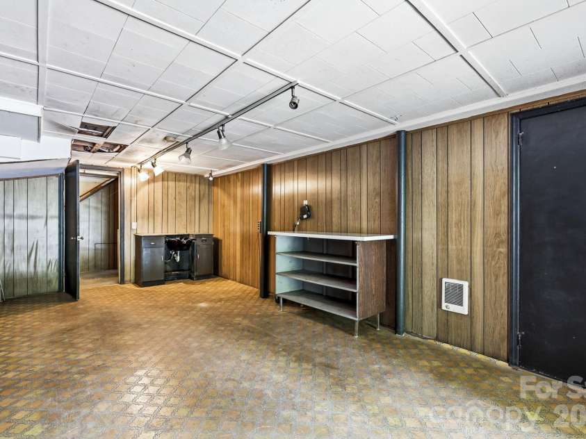27 McGee Circle, Fairview, NC 28730.  MLS# CAR4415904, YatesRealty ID 45673. Generously sized lower-level room offers flexible space for recreation, hobbies, storage, or future improvements.