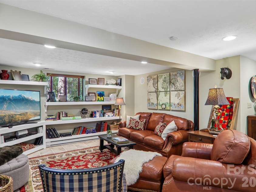 133 Larchmont Drive, Hendersonville, NC 28791.  MLS# CAR4415855, YatesRealty ID 45708. Lower level entertainment space