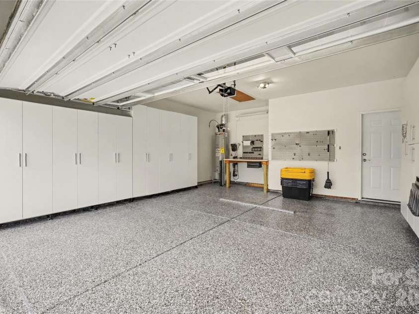 3250 Oliver Stanley Trail, Lancaster, SC 29720.  MLS# CAR4398411, YatesRealty ID 45710. Garage with Custom Cabinets, Epoxy Floor, EV Charger, & Workbench