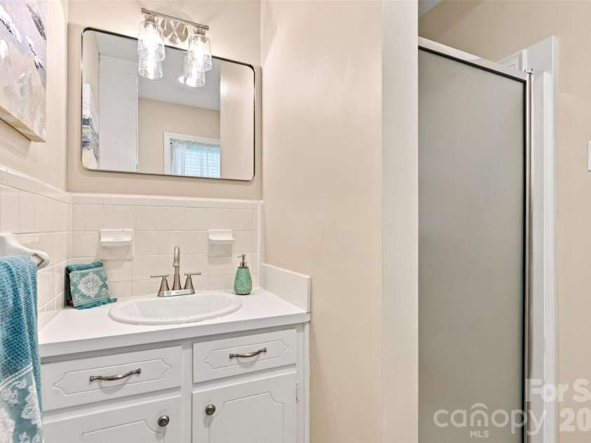 1002 Leewood Drive, Monroe, NC 28112.  MLS# CAR4416687, YatesRealty ID 45719. Ensuite bath in primary with updated lighting