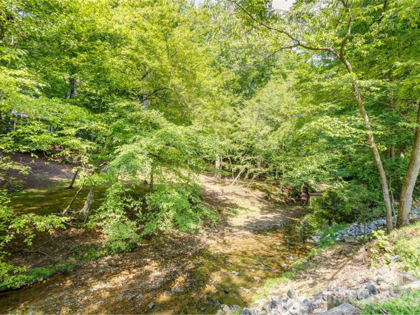 129 Overbrook Drive, Concord, NC 28025.  MLS# CAR4416139, YatesRealty ID 45731. Stream in front yard