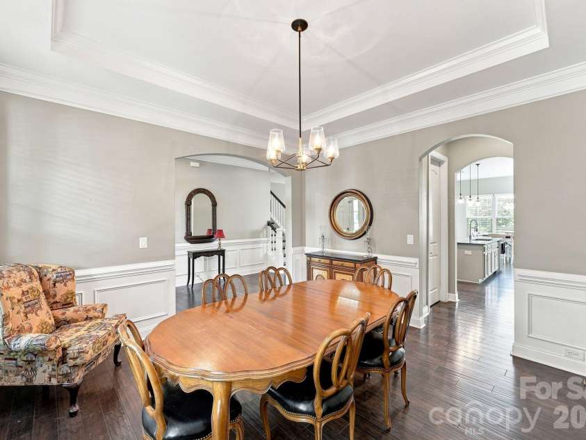 5009 Lydgate Drive, Waxhaw, NC 28173.  MLS# CAR4415096, YatesRealty ID 45758. Dining room features, tray ceiling and wainscoting