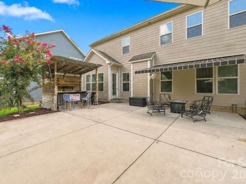 5009 Lydgate Drive, Waxhaw, NC 28173.  MLS# CAR4415096, YatesRealty ID 45758. Enjoy entertaining on this oversized patio featuring tiki bar
