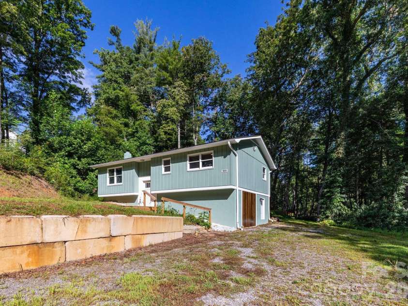 1009 Sharon Ridge Road, Fairview, NC 28730.  MLS# CAR4416738, YatesRealty ID 45809. Front of home with spacious driveway.