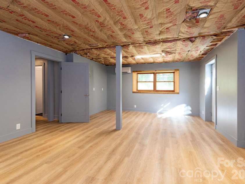 1009 Sharon Ridge Road, Fairview, NC 28730.  MLS# CAR4416738, YatesRealty ID 45809. Partially finished basement area with plumbing hookup installed.