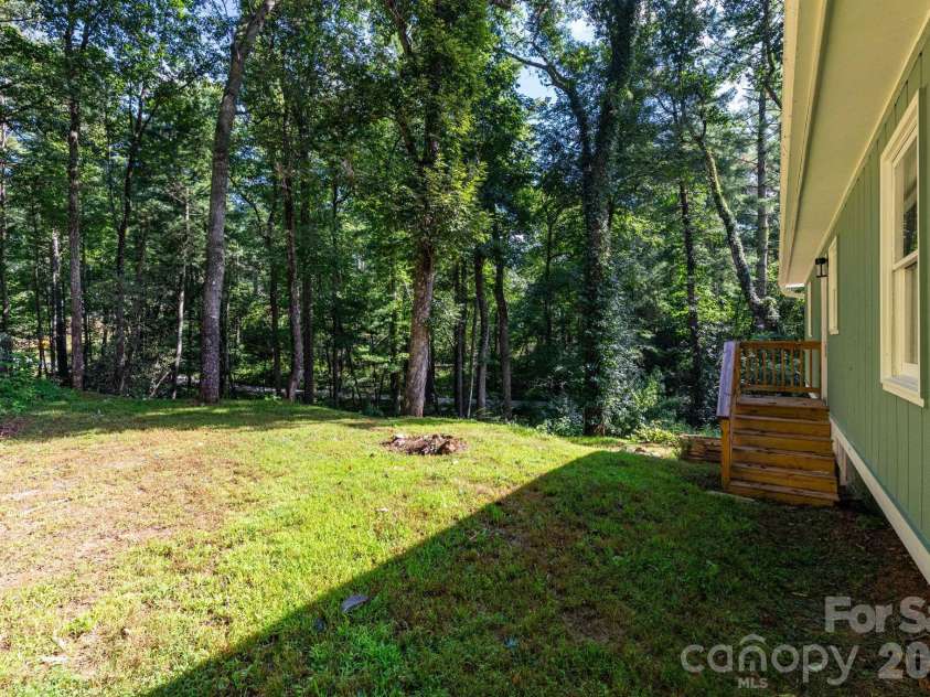 1009 Sharon Ridge Road, Fairview, NC 28730.  MLS# CAR4416738, YatesRealty ID 45809. Wooded backyard.