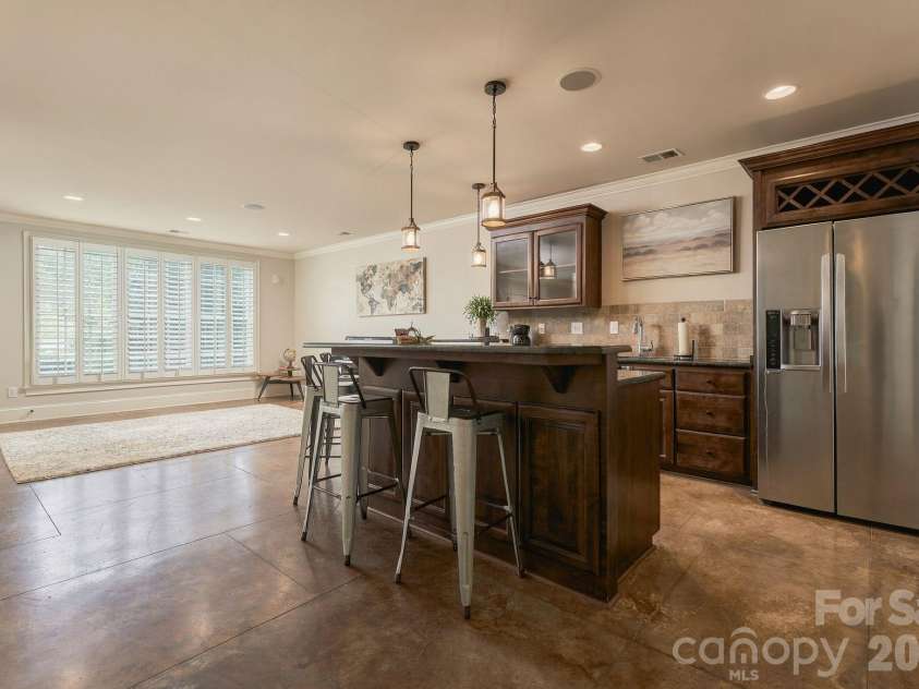7275 Flowes Store Road, Concord, NC 28025.  MLS# CAR4429862, YatesRealty ID 45900. Basement bar/kitchenette features full refrigerator, dishwasher, and sink