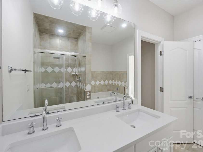 133 Harper Lee Street, Davidson, NC 28036.  MLS# CAR4412095, YatesRealty ID 45903. Refreshed Primary Bathroom, New Vanity, faucets and lighting.