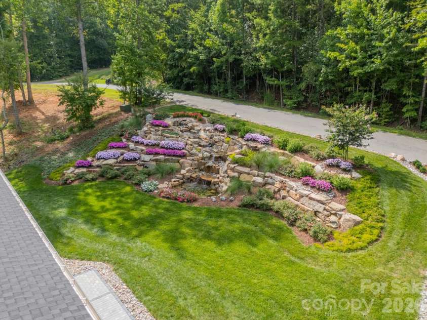 1725 Turtlewood Drive, Waxhaw, NC 28173.  MLS# CAR4407986, YatesRealty ID 45919. Stunning Waterfall-Rock Feature