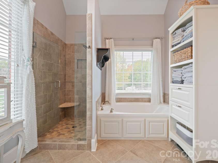 277 Glenwood Drive, Oakboro, NC 28129.  MLS# CAR4312178, YatesRealty ID 45923. Soaking tub and tiled shower