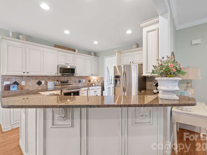 277 Glenwood Drive, Oakboro, NC 28129.  MLS# CAR4312178, YatesRealty ID 45923. Tile backsplash with granite countertops and stainless steel appliances