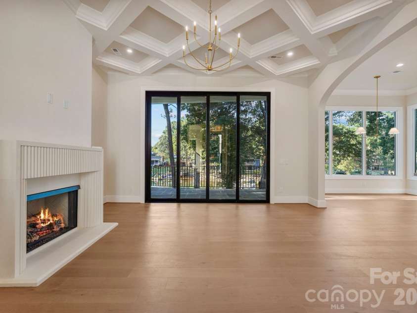 21216 Rio Oro Drive, Cornelius, NC 28031.  MLS# CAR4425303, YatesRealty ID 45943. Family room featuring soaring 12' ceilings and a custom diamond-coffered ceiling that adds architectural detail and character.