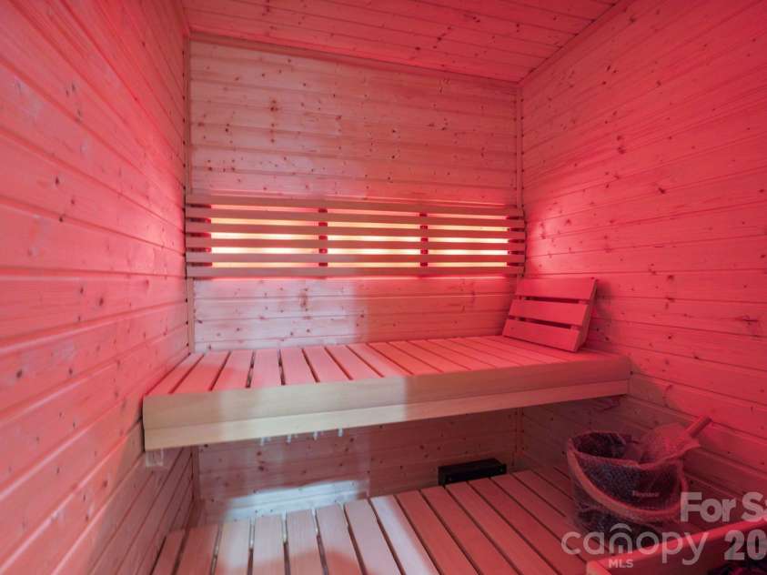 21216 Rio Oro Drive, Cornelius, NC 28031.  MLS# CAR4425303, YatesRealty ID 45943. Private wellness center featuring a built-in sauna, creating a dedicated space for relaxation and recovery in the comfort of home.