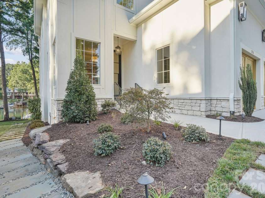 21216 Rio Oro Drive, Cornelius, NC 28031.  MLS# CAR4425303, YatesRealty ID 45943. Professionally designed luxury landscaping enhanced by architectural night lighting, beautifully highlighting the home and grounds after sunset