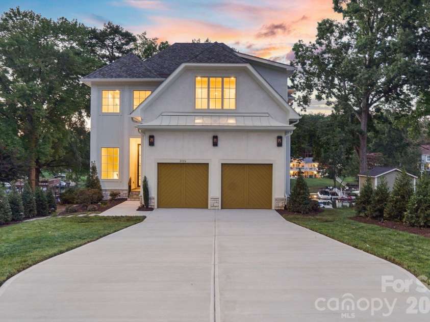 21216 Rio Oro Drive, Cornelius, NC 28031.  MLS# CAR4425303, YatesRealty ID 45943. Stunning luxury new construction showcasing timeless architecture, elevated exterior finishes, and exceptional curb appeal.